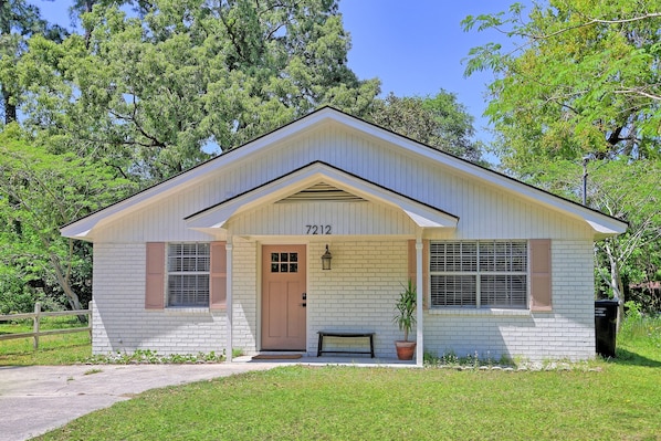The charming painted brick exterior adds the perfect touch of character—welcoming you home with a little Southern flair.