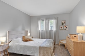 Relax in the spacious primary bedroom featuring an ensuite bath — perfect for unwinding in comfort and style.