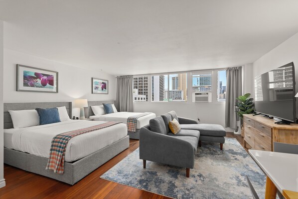 Spacious studio apartment with 2 queen beds, sectional sofa, dresser and 65" TV