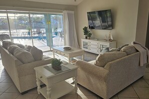 The comfortable living room includes a 65" smart TV. 
