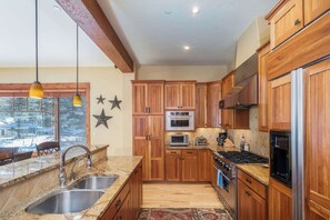 Kitchen: Drip coffee maker, stovetop kettle, cooking utensils, tableware