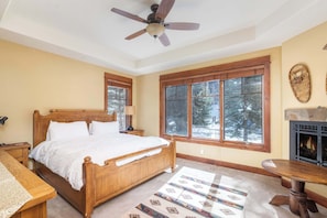 Bedroom 3: California king bed, en-suite bathroom, Smart TV, dresser, walk-in closet, ceiling fan, fireplace