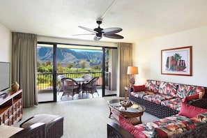 Spacious living room with a sleeper sofa and TV