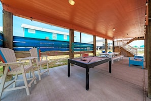 Fun awaits under the home for outdoor dining and games!