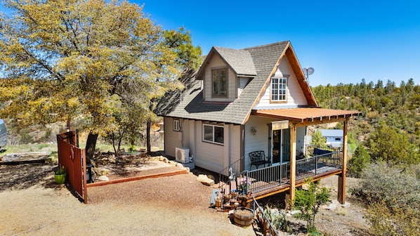 A cozy A-frame retreat nestled at the base of Thumb Butte, surrounded by towering pines and endless mountain views—your perfect Prescott escape!