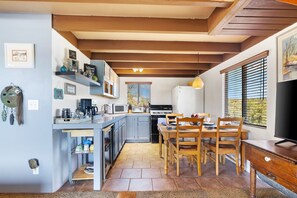Enjoy home-cooked meals and morning coffee in this bright, fully equipped kitchen and dining space—framed by forest views and cozy cabin charm. ☕🍽️🌲
