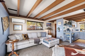 Cozy up in this rustic-chic living space featuring warm beams, southwest charm, and all the comforts of home! 🛋️🌵✨
