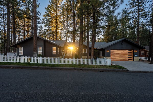 Front of home highlighted by setting sun