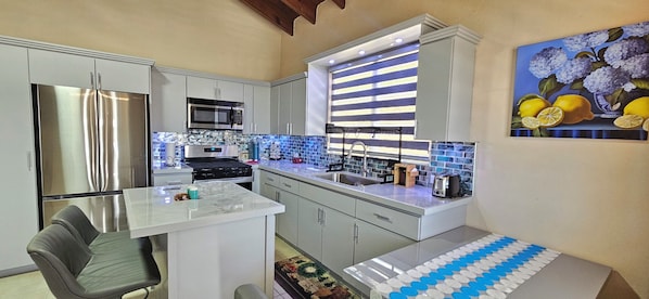 Fully stocked kitchen with all new appliances and plenty seating