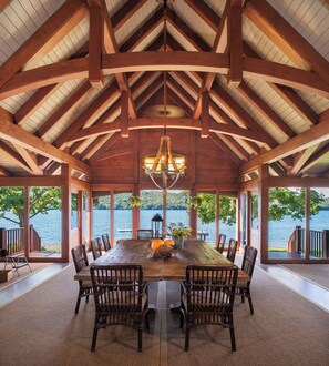 Oversized dining table in screened-in porch