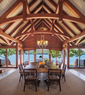Oversized dining table in screened-in porch