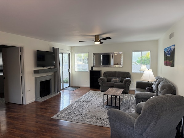 Large open concept living room and dining room with covered patio.