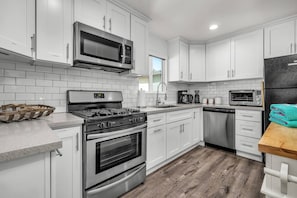 Cook all your favorite meals in our fully equipped modern kitchen. Appliances include dishwasher, refrigerator, oven/stove, and microwave.