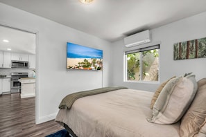Primary bedroom with Queen size bed, ensuite full bathroom and 55" SmartTV