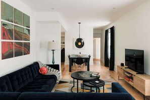 Open concept living room, dining + kitchen