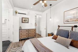 The primary bedroom has plenty of space for storing your clothing during your trip. (Inside the cabinet, you'll find an iron, ironing board, and hairdryer.) 