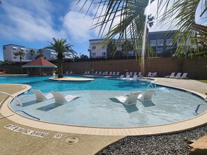 Newly renovated main pool with sun ledges and lounge chairs.
