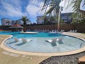 Newly renovated main pool with sun ledges and lounge chairs.
