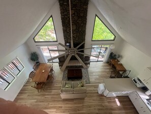 Great Room picture from upstairs: fireplace, TV, dining areas, kitchen, etc.