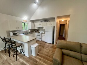 Full kitchen and extra dining area at countertop and love seat.