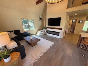 Living room with fireplace and smart tv.