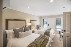 This inviting bedroom offers private outdoor access and natural light from every angle—ideal for a peaceful retreat after your Napa adventures.
