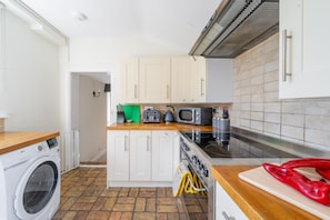 Ground floor: Kitchen with washing machine, dish washer, oven and induction hob