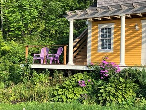 Outdoor guest area on front deck (stairs behind are private access to studio)