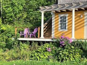 Outdoor guest area on front deck (stairs behind are private access to studio)
