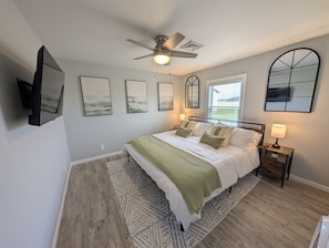 Bedroom #1 with a king sized bed and Helix mattress - your ultimate spot for relaxation after a long day of adventure.
