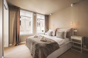 The bedroom boasts large windows, letting in plenty of natural light.
