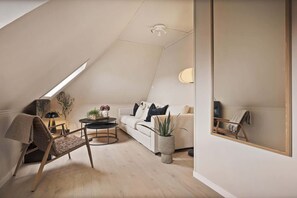 A cozy attic living space, bathed in natural light.