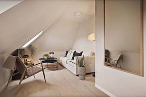 A cozy attic living space, bathed in natural light.