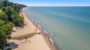 Access Lake Michigan beach at Pier Cove or Westside County Park
