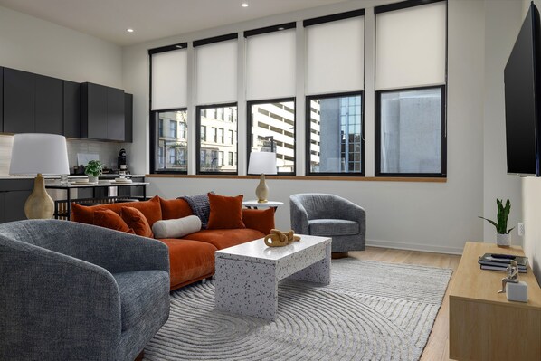 Entertainment and productivity combined—this cozy living area features a large TV, Xbox, and a versatile lift-top coffee table that doubles as a convenient workspace.
