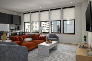 Breathtaking views—enjoy the cityscape of downtown Birmingham through large windows while relaxing on the comfortable, modern seating in this sun-filled living room.