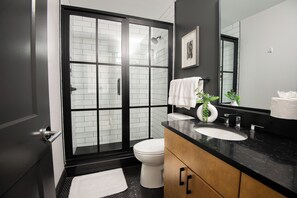 Indulge in the sleekness of our modern bathroom, equipped with a spacious shower to rejuvenate after a day of adventure.