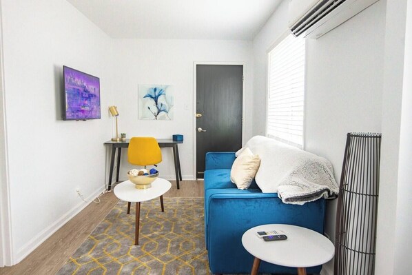 Welcome to Vulcan's Hideout!!  Cozy living room view from kitchen, equipped with a couch, smart TV and a workspace. 