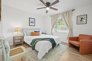 Welcome to your hideaway! This inviting bedroom features a plush queen-sized bed, adorned with soft linens and fluffy pillows, ensuring a restful night's sleep. 