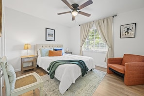 Welcome to your hideaway! This inviting bedroom features a plush queen-sized bed, adorned with soft linens and fluffy pillows, ensuring a restful night's sleep.
