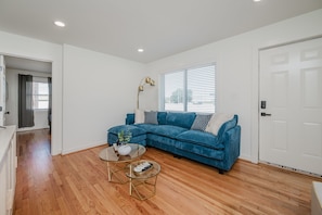 Spacious living room with comfortable seating and modern décor, perfect for relaxation or entertainment.