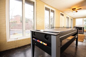 The game room features a stylish billiard table, ample lighting, and cozy seating—perfect for fun, friendly games and quality time with family or friends.