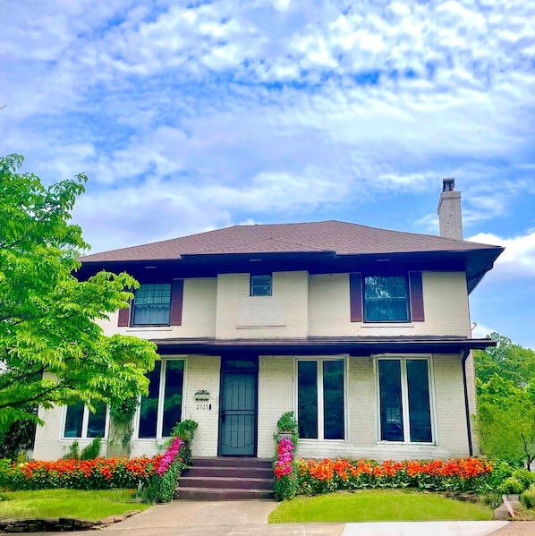 Welcome to Hanover – where timeless charm meets vibrant curb appeal. This stately home greets you with colorful blooms, classic architecture, and inviting entrance perfect for your next stay.