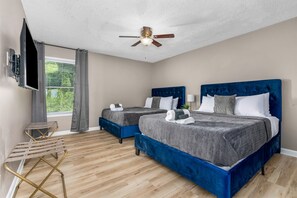 Stylish bedroom with queen beds, perfect for kids or additional guests.