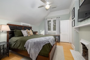Enjoy a restful night's sleep on our comfortable queen bed, tastefully accented with soothing greens for a peaceful retreat.
