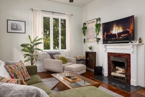 Relax in our inviting living room with a flatscreen TV and cozy seating – your ideal space for unwinding and entertainment.