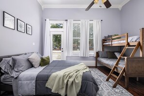 Our inviting bedroom is a haven of comfort and versatility. With a full-sized bed and a queen twin bunk bed, it accommodates various guests. The soothing green accents create a tranquil atmosphere, and for your entertainment, there's a TV in every room!