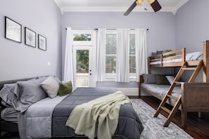 Our inviting bedroom is a haven of comfort and versatility. With a full-sized bed and a queen twin bunk bed, it accommodates various guests. The soothing green accents create a tranquil atmosphere, and for your entertainment, there's a TV in every room!