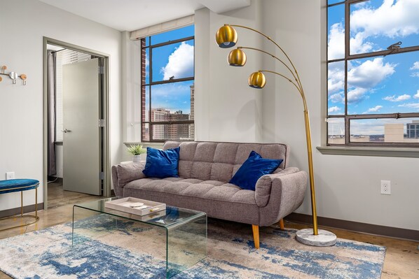 Bright and open living space with modern furnishings and stunning city views.