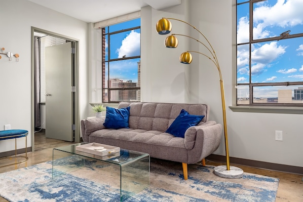 Bright and open living space with modern furnishings and stunning city views.